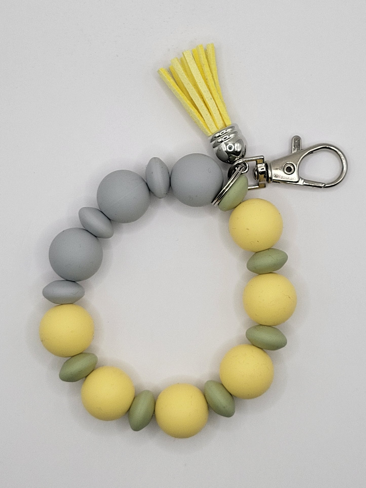 Pochette-bracelet jaune pâle, vert jasmin, gris glacier